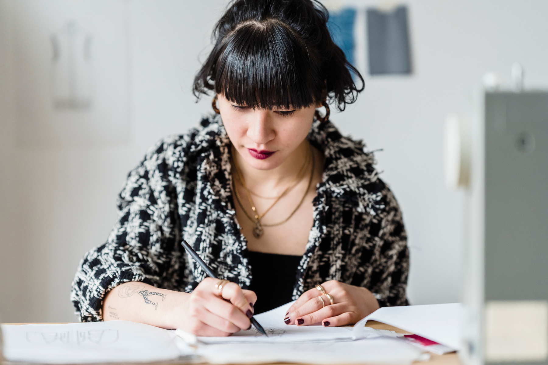 Focused Asian woman drawing sketch in atelier